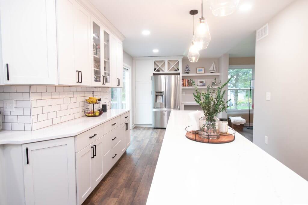 finished kitchen remodel with island countertop and stainless appliances by Odd Fellows Contracting in Cumberland Lansing MI