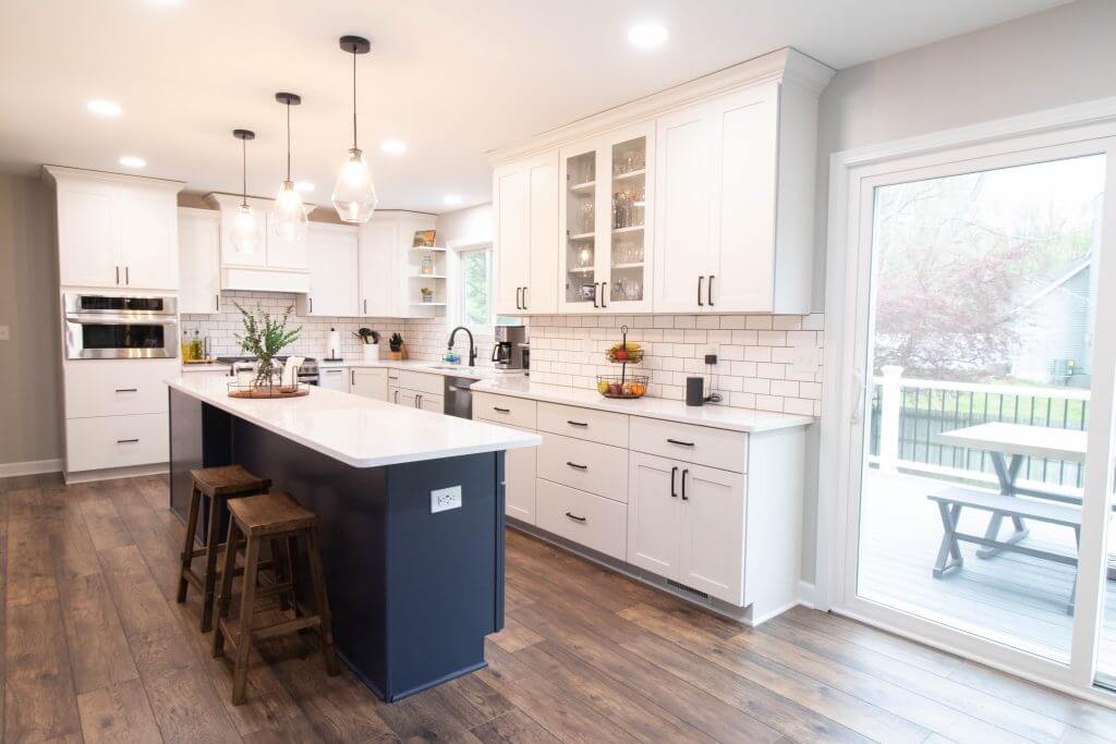 kitchen renovation featuring island seating and bright modern cabinetry by Odd Fellows Contracting in Cumberland Lansing MI