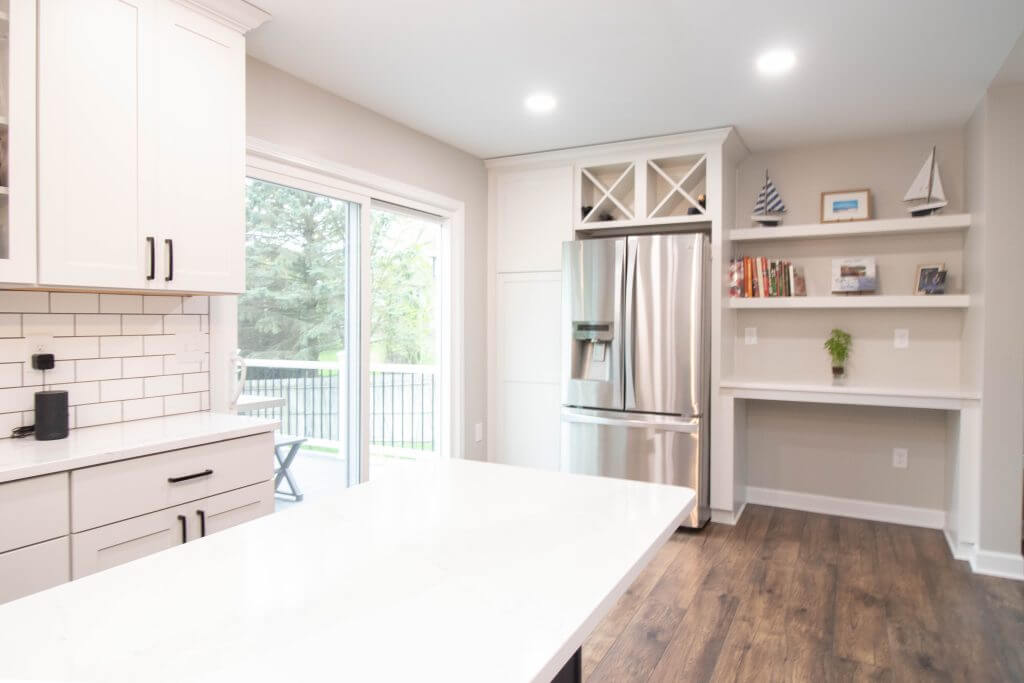 remodeled kitchen island with pendant lighting and seating by Odd Fellows Contracting in Cumberland Lansing MI