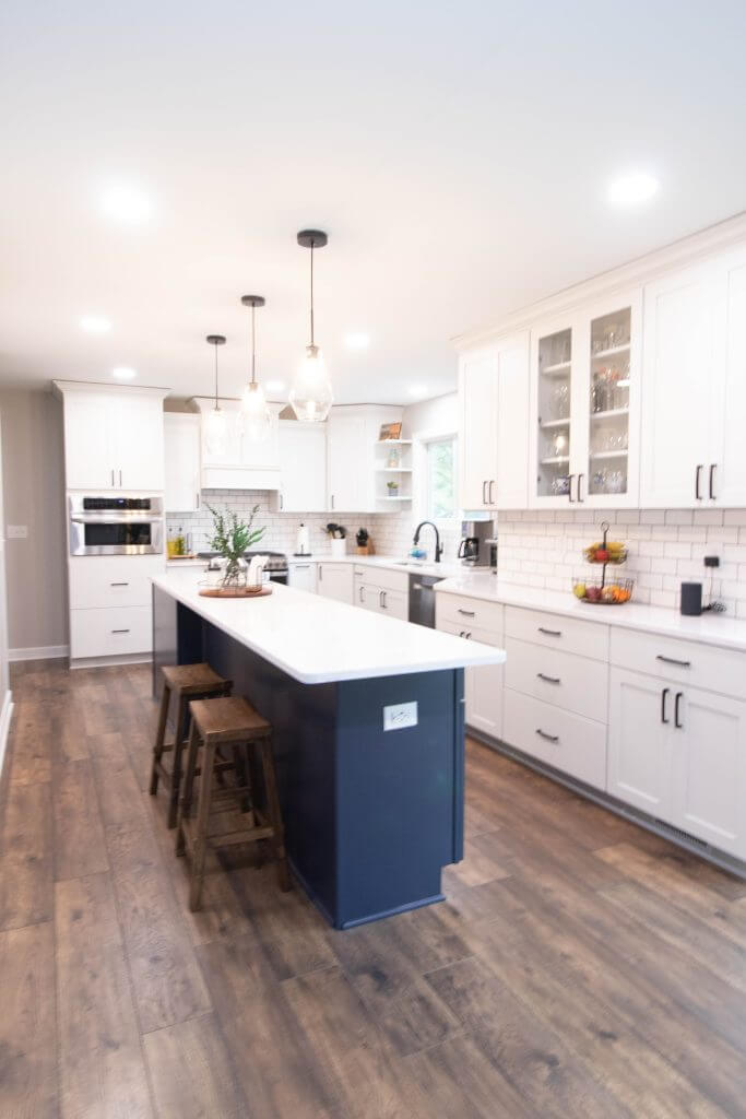 remodeled kitchen with large island and pendant lighting by Odd Fellows Contracting in Cumberland Lansing MI