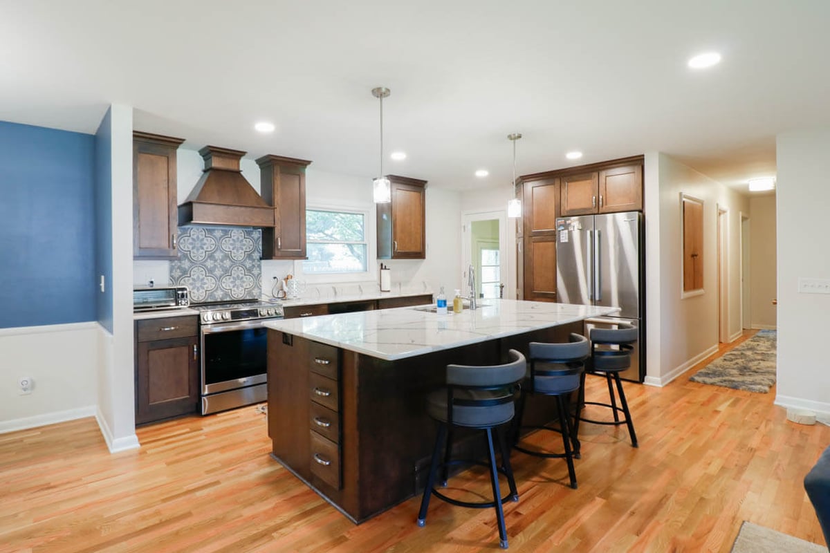 Cornell Okemos, MI custom home kitchen by Odd Fellows Contracting featuring wood cabinetry and quartz countertops