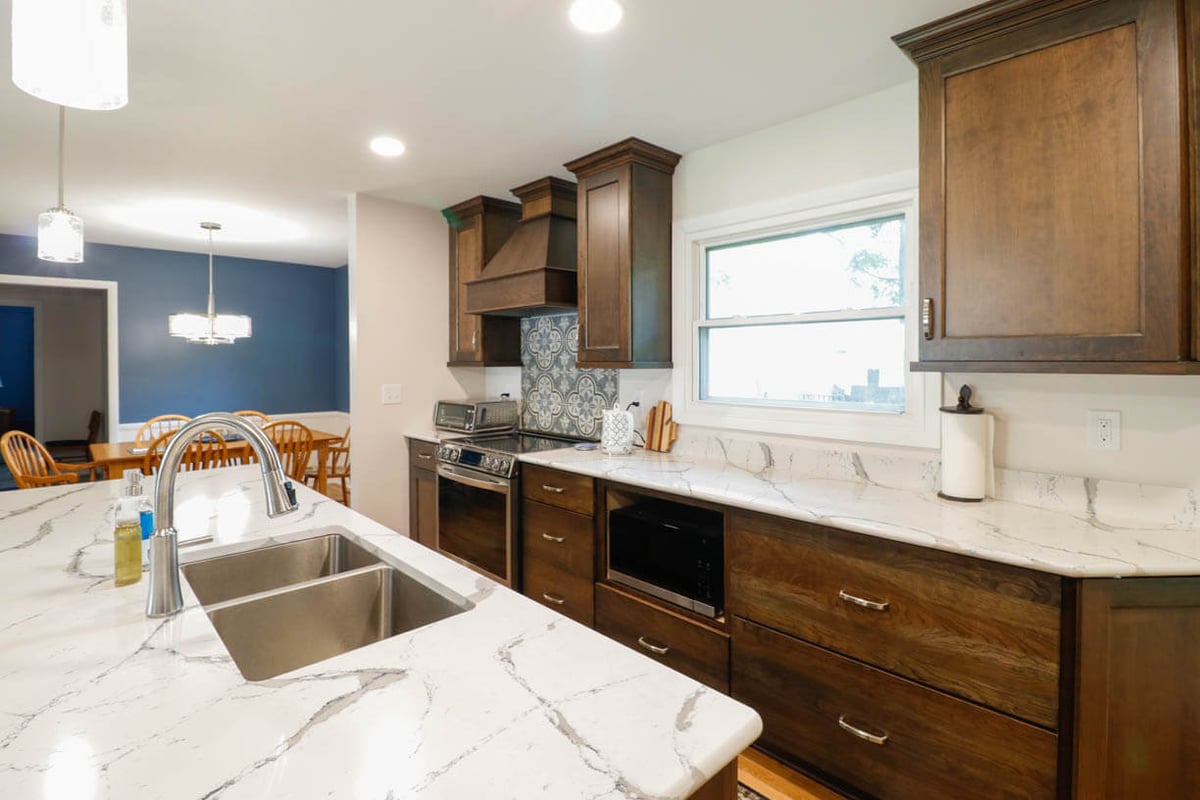 Cornell Okemos, MI custom home kitchen by Odd Fellows Contracting showcasing island sink and cabinetry