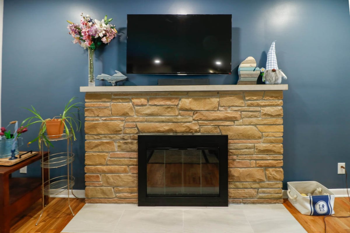 Cornell Okemos, MI custom home living space by Odd Fellows Contracting featuring fireplace and blue accent wall
