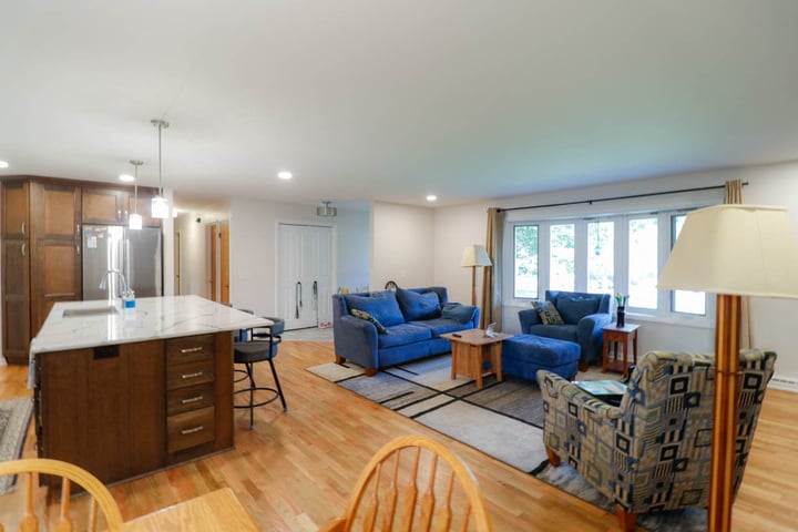 open concept custom home kitchen and living room by Odd Fellows Contracting in Cornell Okemos, MI