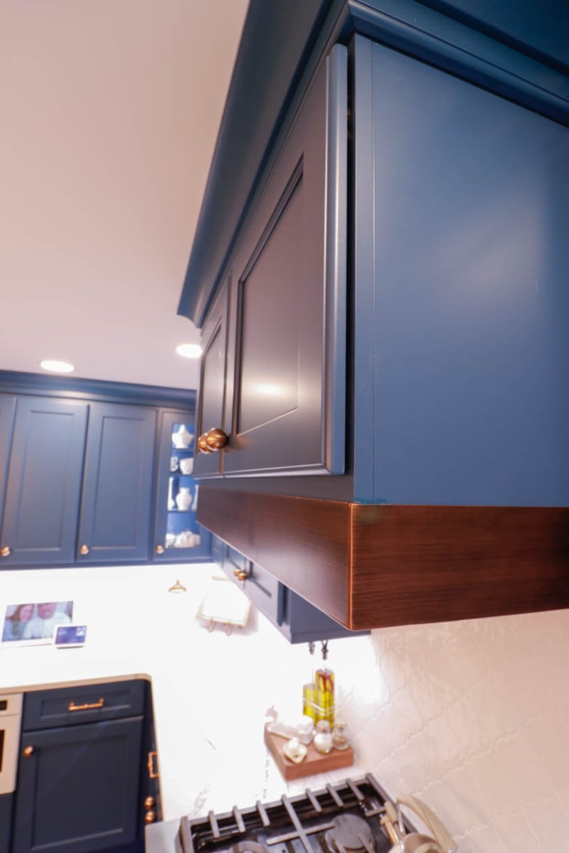 Close-up of custom blue kitchen cabinetry in a Tacoma Hills, MI custom home by Odd Fellows Contracting.