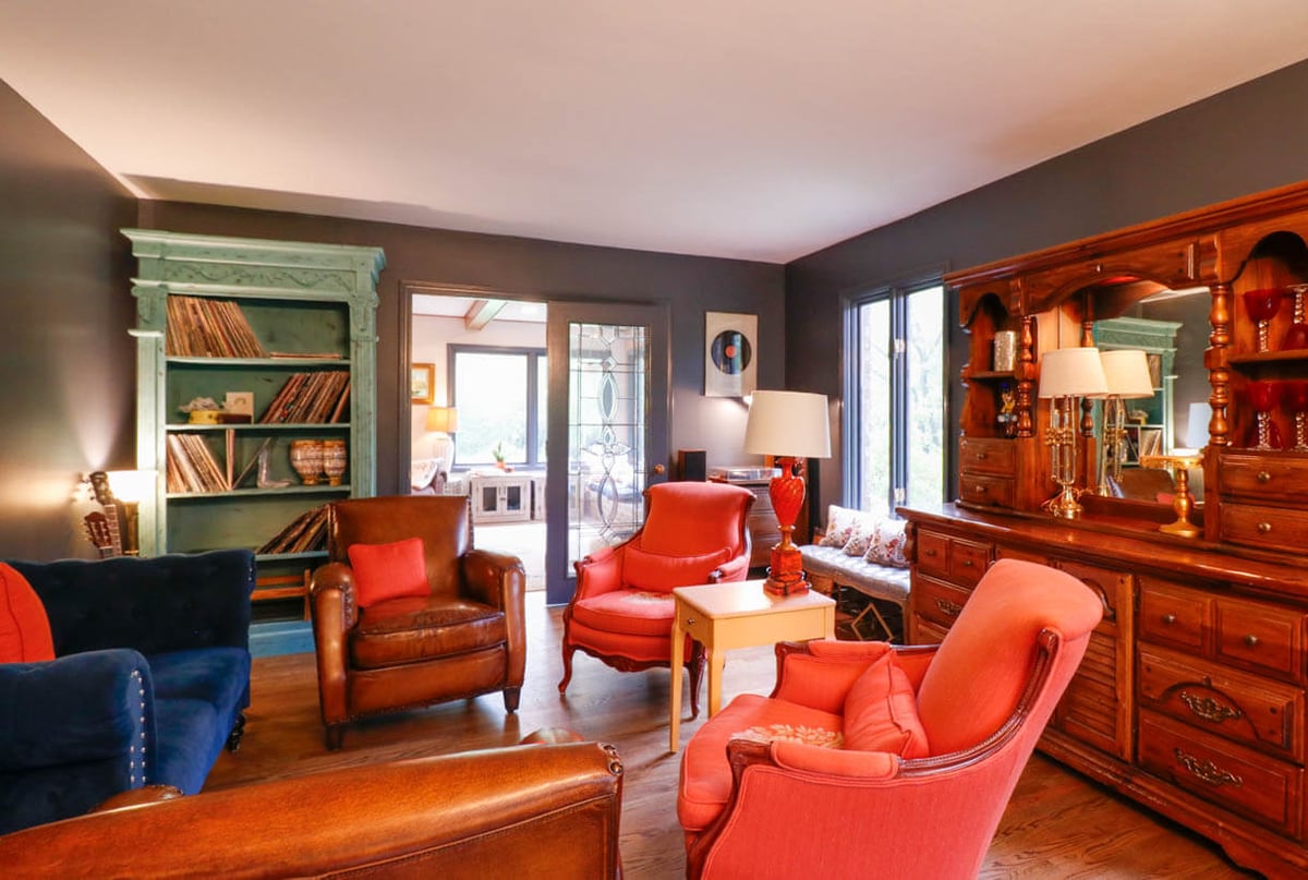 Living room remodel in a Tacoma Hills, MI custom home by Odd Fellows Contracting with bold accent walls and hardwood floors.