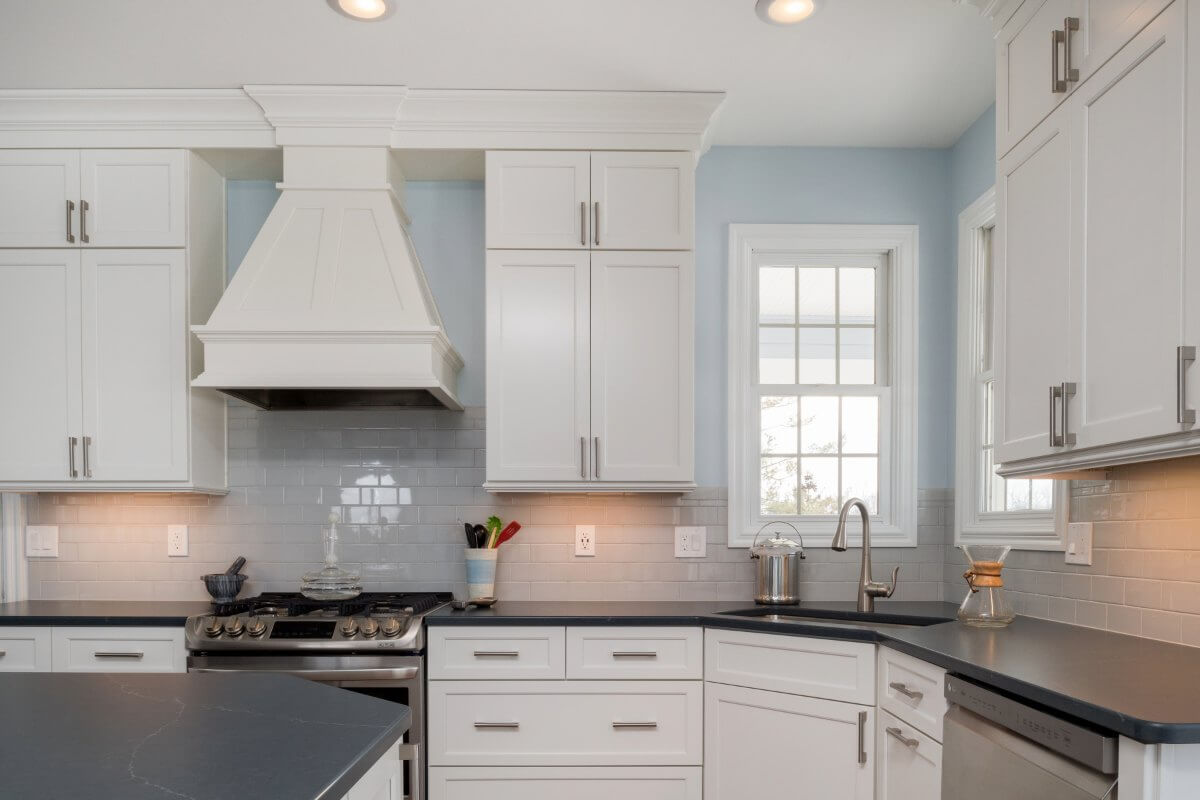 White shaker cabinets with stainless appliances in Bath Township kitchen remodel by Odd Fellows Contracting