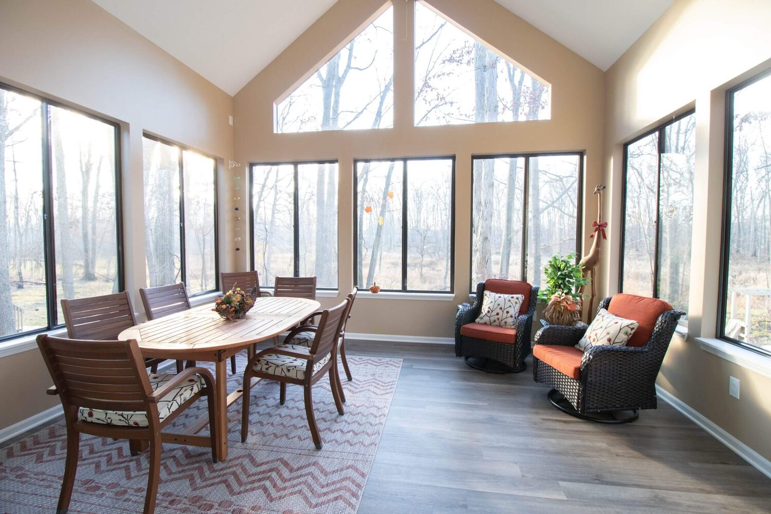 sunroom interior with vaulted ceiling and dining table by Odd Fellows Contracting in Haslett MI
