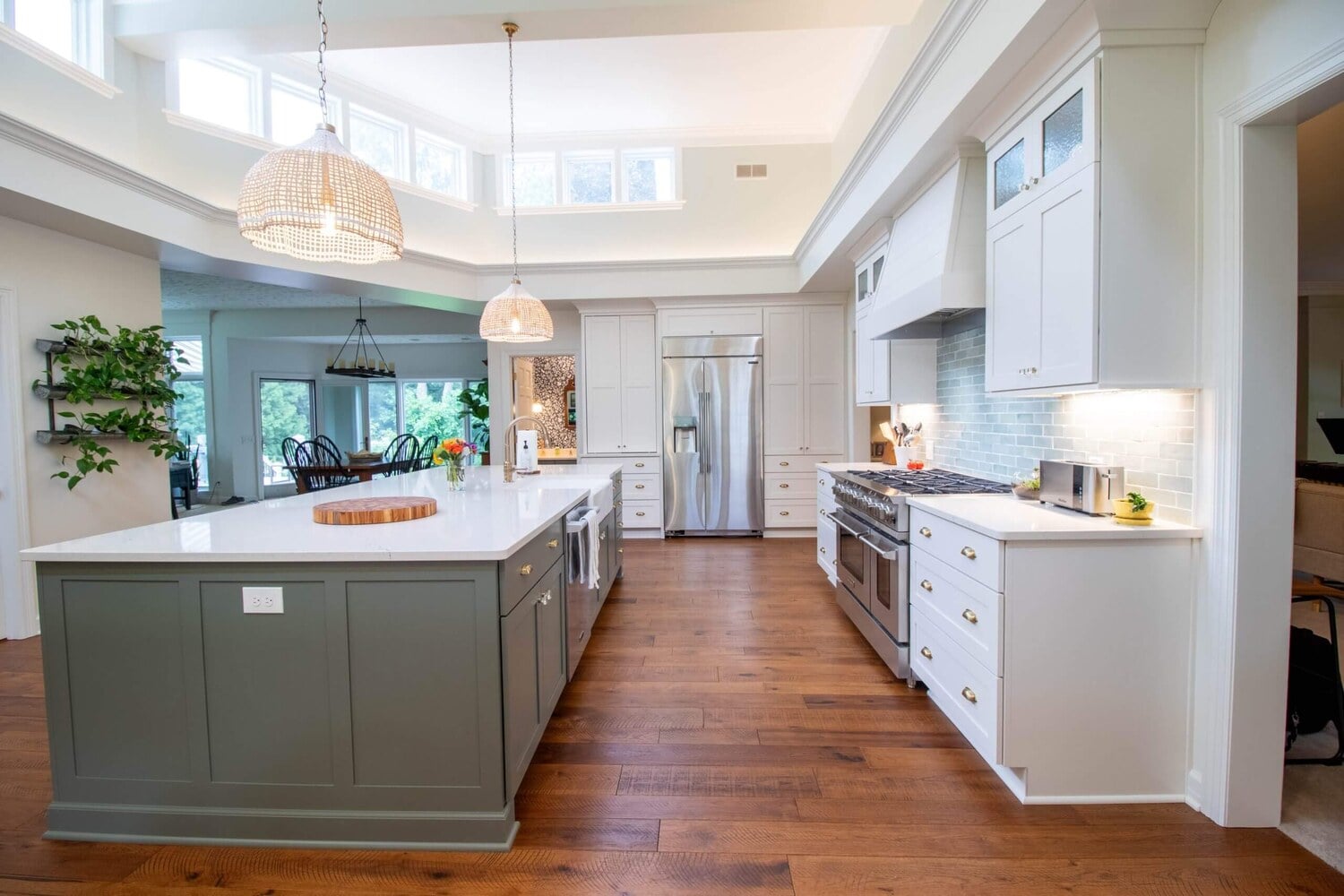 Bright open kitchen remodel by Odd Fellows Contracting in Okemos, MI featuring expansive island