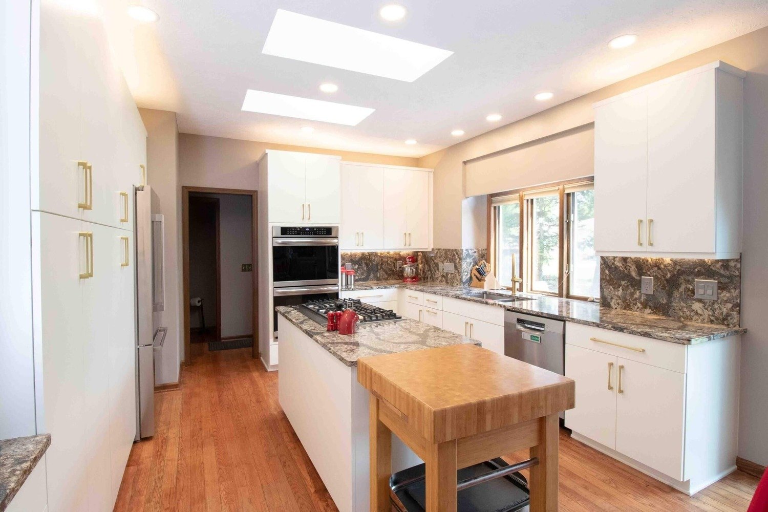 kitchen remodel featuring large window over sink and granite countertops by Odd Fellows Contracting in Lansing MI