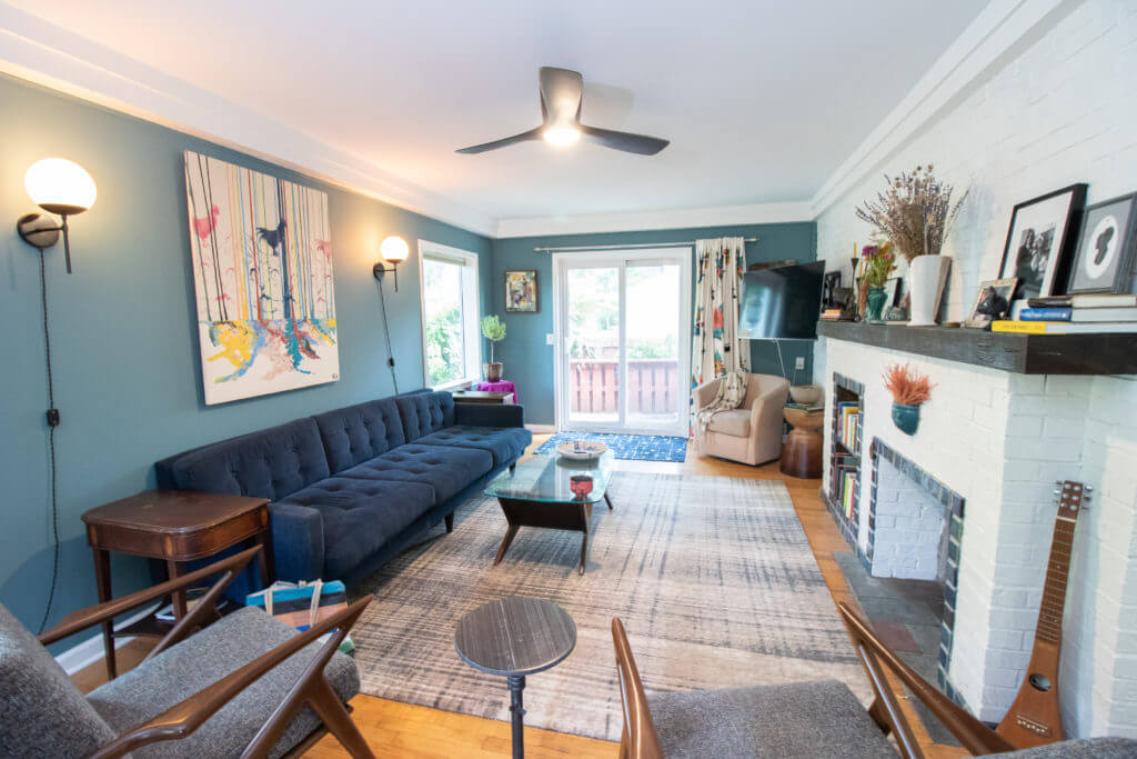 Living room remodel with updated fireplace and modern lighting by Odd Fellows Contracting in East Lansing, MI