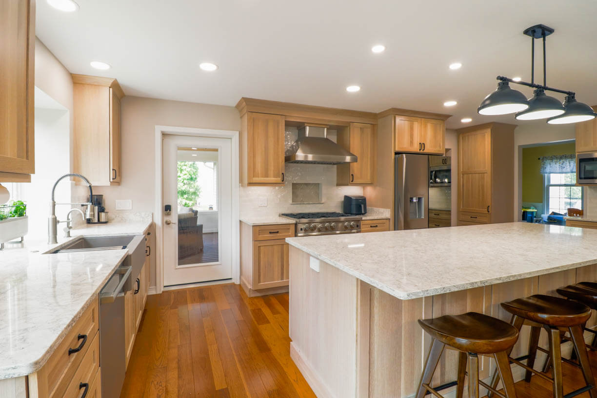 Cornell Woods, MI custom home kitchen by Odd Fellows Contracting featuring expansive quartz countertops and open design.