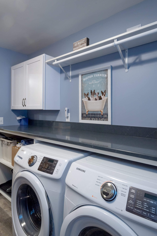 laundry room renovation with washer dryer and wall-mounted shelving by Odd Fellows Contracting in Lansing, MI