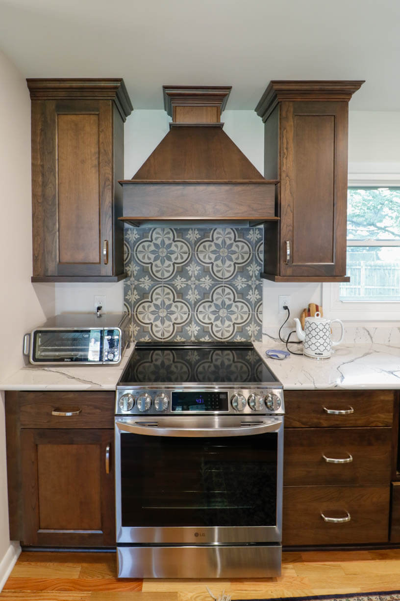 custom home kitchen range wall by Odd Fellows Contracting in Cornell Okemos, MI with decorative tile backsplash
